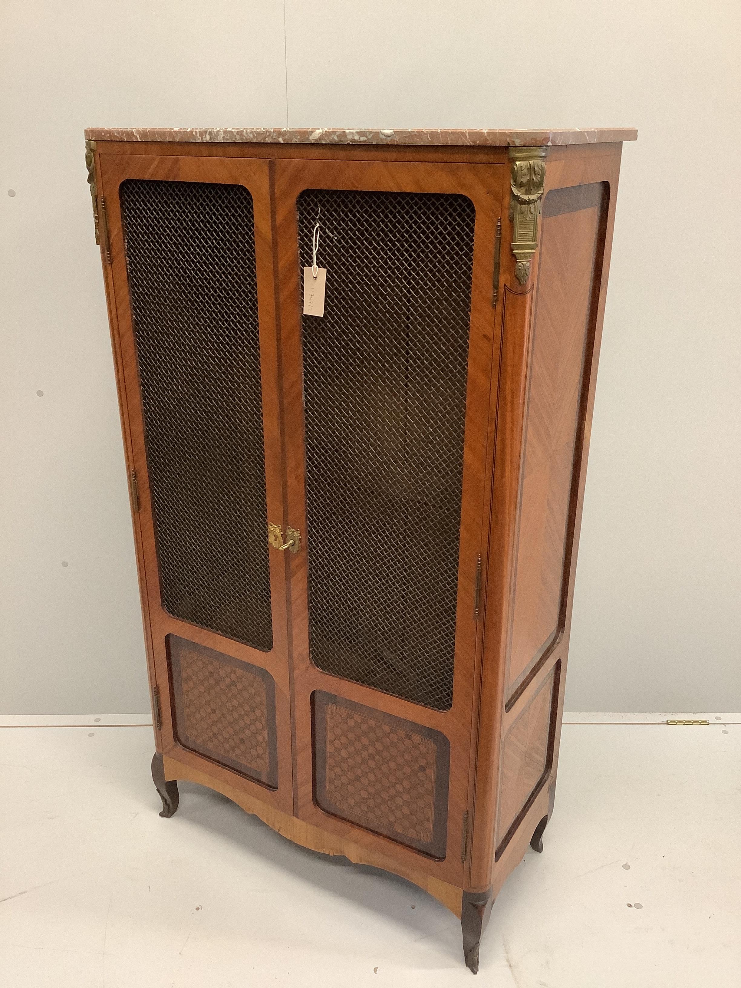 A French transitional style marble topped kingwood side cabinet, width 83cm, depth 40cm, height 145cm